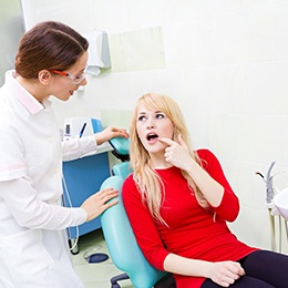 Woman and dentist discussing tooth extractions in Arlington 