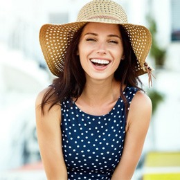 Woman smiling with dental crown in Arlington  