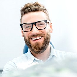 patient smiling while sitting in dental chair