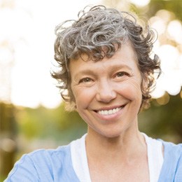 patient smiling while standing outside 