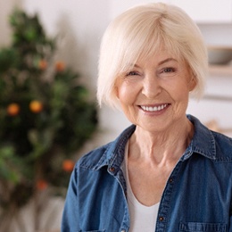 Woman smiling with dentures in Arlington