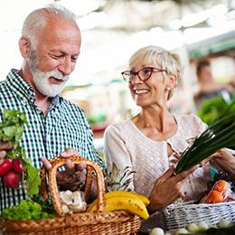 older couple shopping for vegetables together 