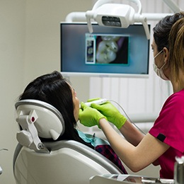A dentist examining a patient’s problem tooth in Arlington