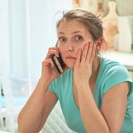 Concerned woman calling her Arlington emergency dentist