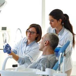 dentist and patient discussing cost of dental emergencies in Arlington