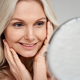 Woman smiling with dental implants in Arlington