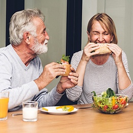 Smiling couple eating together