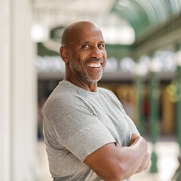 Confident smiling man wearing a grey shirt