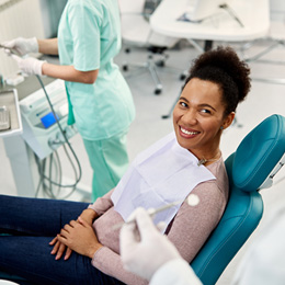 Dentist talking to female patient 