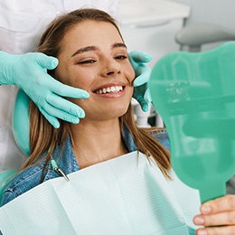 woman smiling in dental mirror 