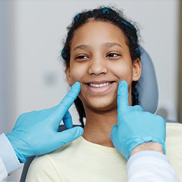 A teen girl smiling at her dentist