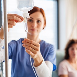A nurse setting up a patient’s IV
