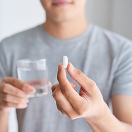 patient holding oral conscious sedative