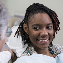 Woman learning to prevent dental emergencies in Arlington