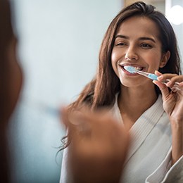 Woman brushes teeth in Arlington