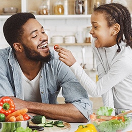 Father and daughter eating salad in Arlington