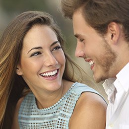 Young couple smiling after cosmetic dentistry treatment