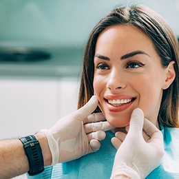 dentist looking at woman’s smile 