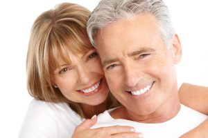 couple smiling about tooth replacement