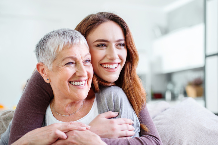 smiling grandmother and granddaughter