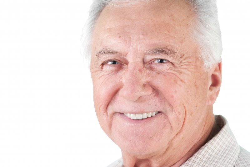 older man with dentures smiling