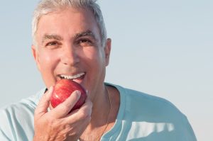 man biting apple