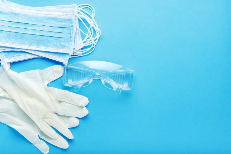 an image of facial masks, protective eyewear, and gloves