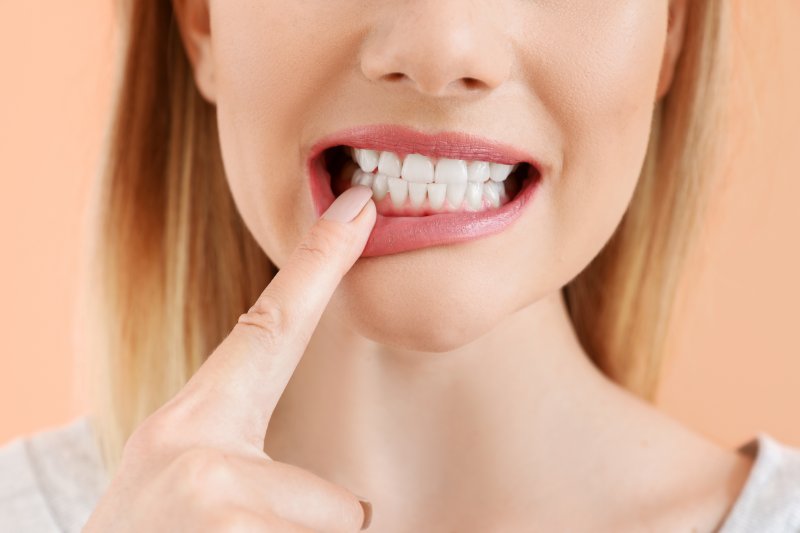 woman pointing to her tooth in Arlington