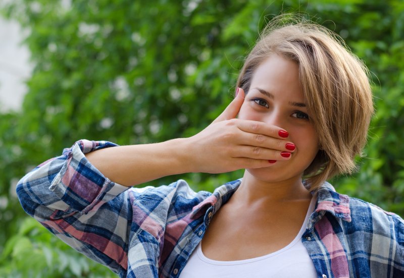 a woman covering her mouth
