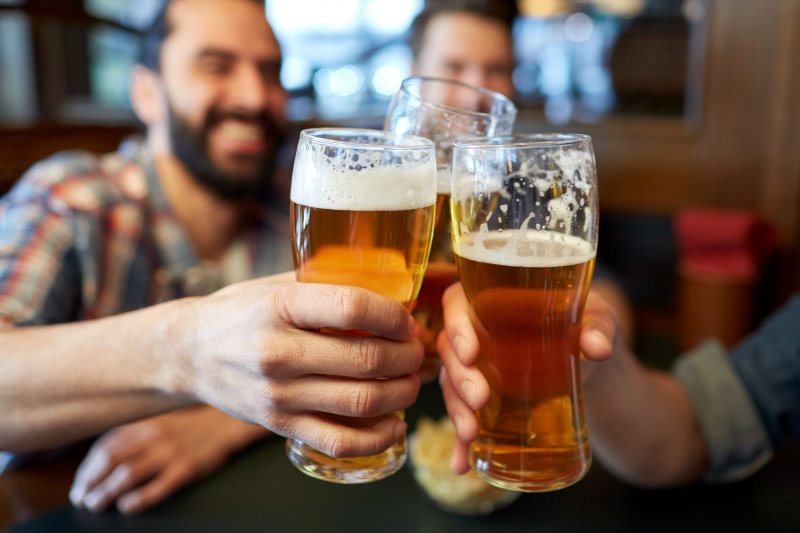 friends smiling and drinking beer 