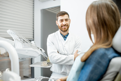 dentist smiling while talking to patient