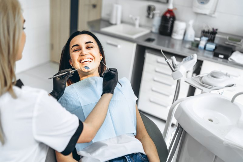 A dentist about to prepare her patient’s teeth for dental crowns